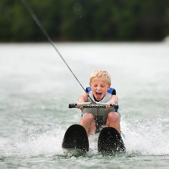 Young boy water skiiing